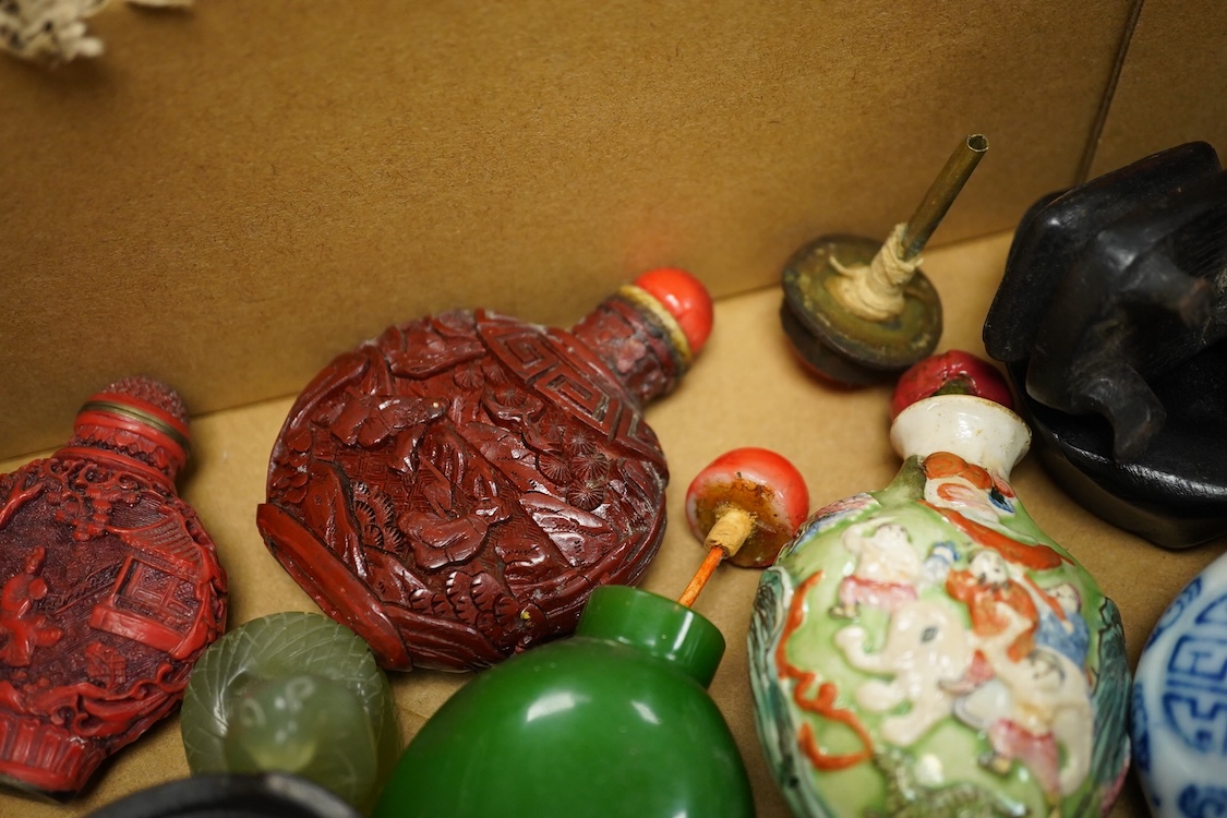 A small collection of Chinese snuff bottles, 19th century and later to include reverse glass painted examples and cinnabar lacquered examples, largest 9.5cm high